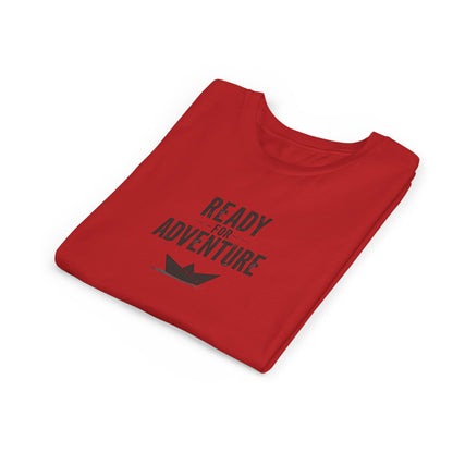 Kids folded red T‑shirt with bold black “Ready for Adventure” text and a small paper boat graphic.