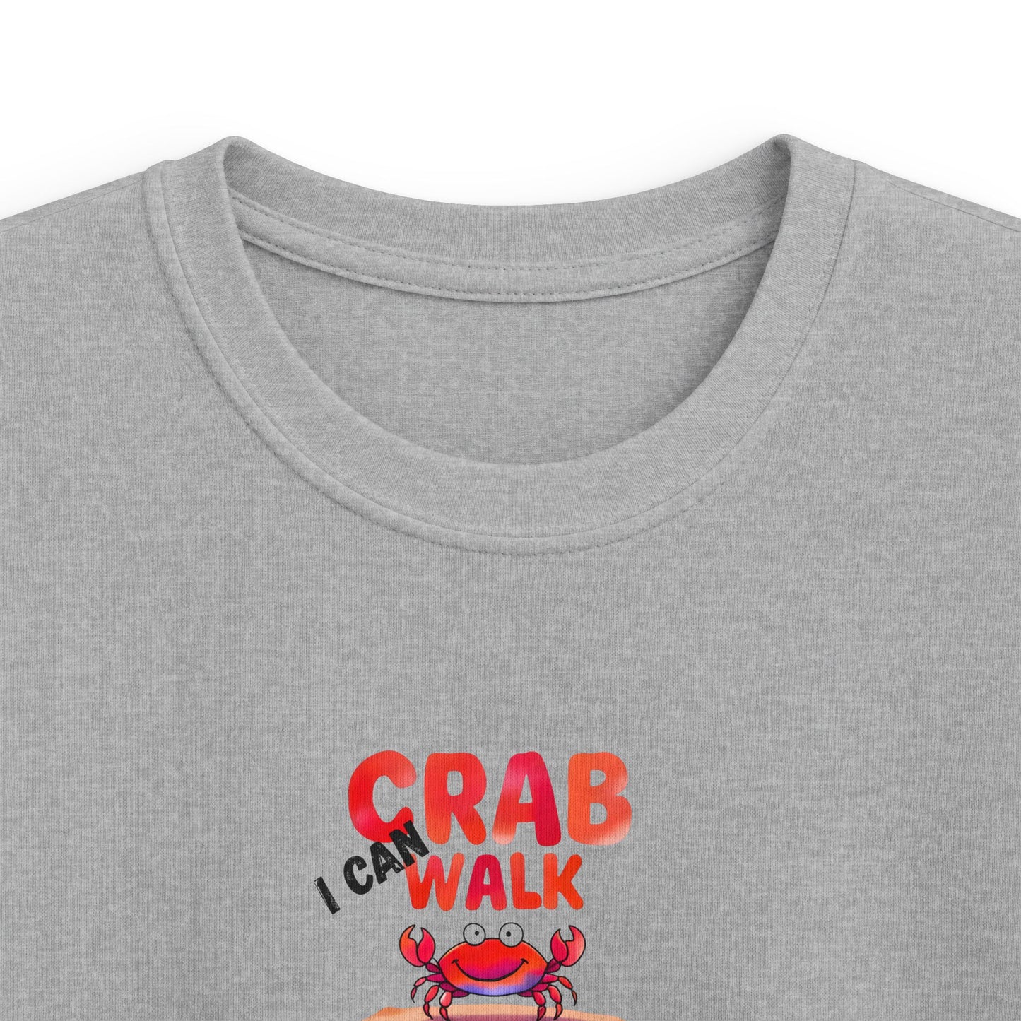 Close-up of a heather gray crewneck t-shirt featuring a graphic print that reads 'I CAN CRAB WALK' in red and black text above a cartoon red crab.