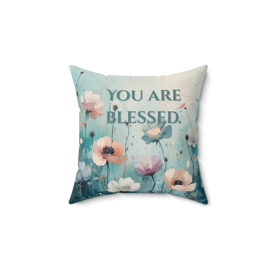 Decorative pillow with floral design and 'You are Blessed' text on a white background