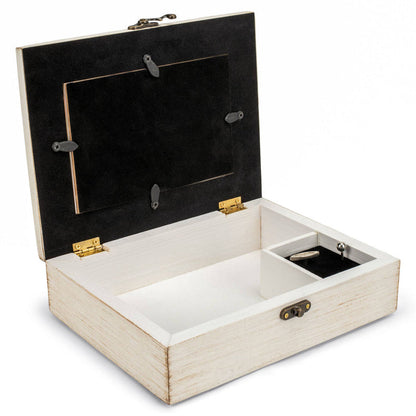 Wooden jewelry box with black interior with windup music key on a white background