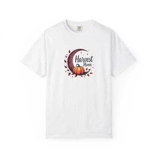 A white short-sleeve crewneck t-shirt featuring a central graphic of a crescent moon, autumn leaves, a pumpkin, and the text 'Harvest Moon' in dark brown script.