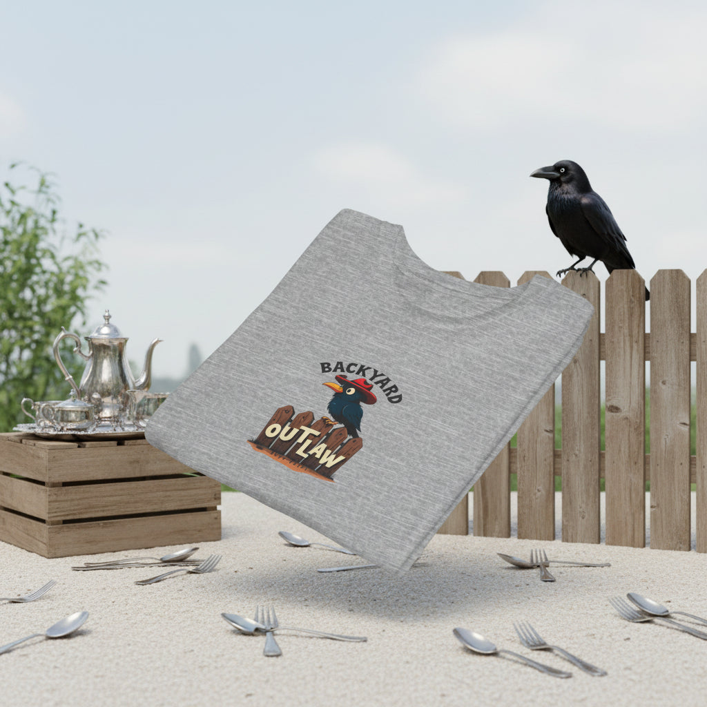 Folded grey T-shirt. Text says, "Backyard Outlaw" with a cartoon crow Graphic of a black row wearing a red cowboy hat and sitting on a wooden fence.