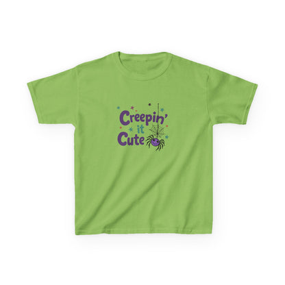 An orange short-sleeve kids' t-shirt with a 'Creepin' Cute' Halloween graphic on the chest, featuring purple text, a spider, and small stars, displayed on a clean white background. Lime