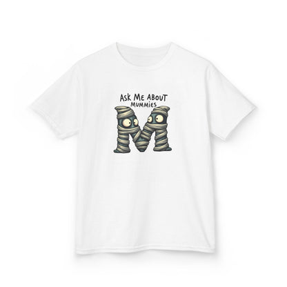 A white short-sleeve crewneck t-shirt featuring a graphic of two cartoonish mummies forming the letter 'M' with the text 'ASK ME ABOUT MUMMIES' above it, displayed on a clean white background.