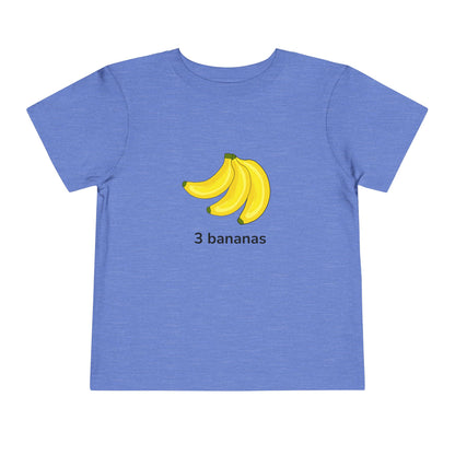 A heather blue short-sleeve t-shirt with a graphic of three yellow bananas and the text '3 bananas' printed on the chest, shown against a plain white background.