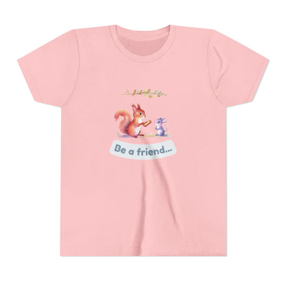 Pink t-shirt with a cartoon squirrel and mouse design and 'Be a friend' text on a white background