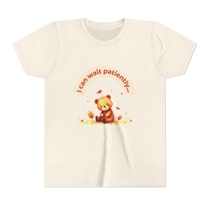 Beige t-shirt with a teddy bear graphic and text on a white background