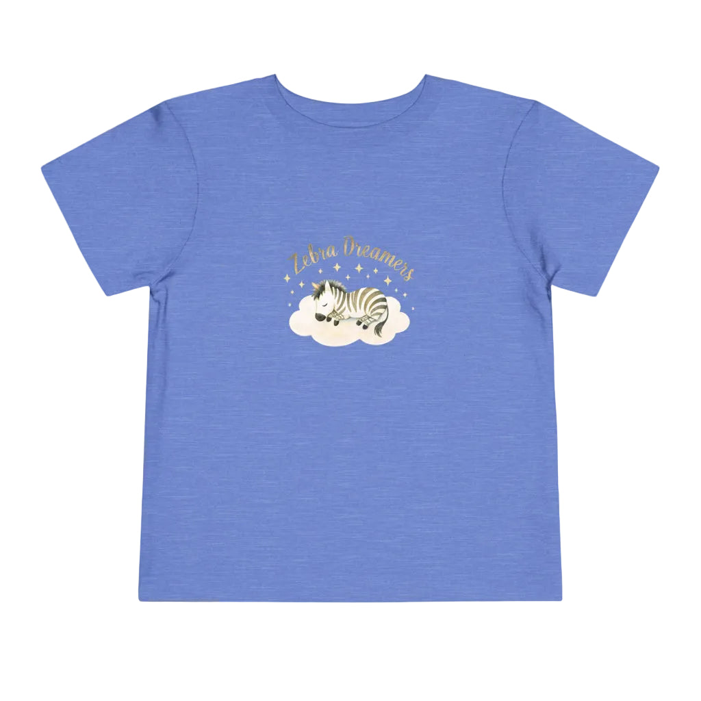 Blue t-shirt with a zebra graphic and text on a white background. Toddler t-shirt with a sleeping watercolor zebra curled on a cloud and text reading ‘Zebra Dreams.’