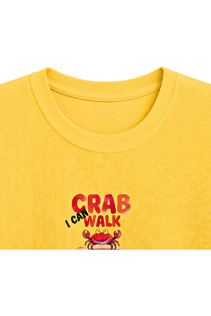 A close-up of a yellow crewneck t-shirt featuring a graphic print on the chest that reads 'I CAN WALK LIKE A CRAB' in red and black text above a cartoon crab illustration.