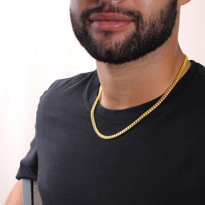 Man wears gold Cuban link chain necklace,