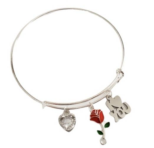 Silver bracelet with charms including a heart, rose,  on a white background