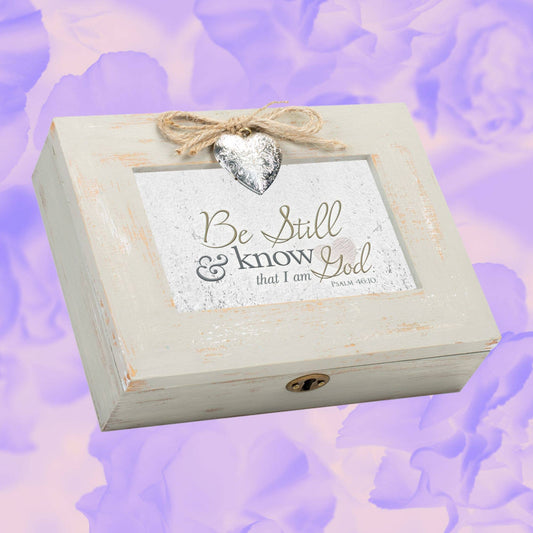 Wooden box with 'Be Still & Know That I Am God' text on a soft purple floral background