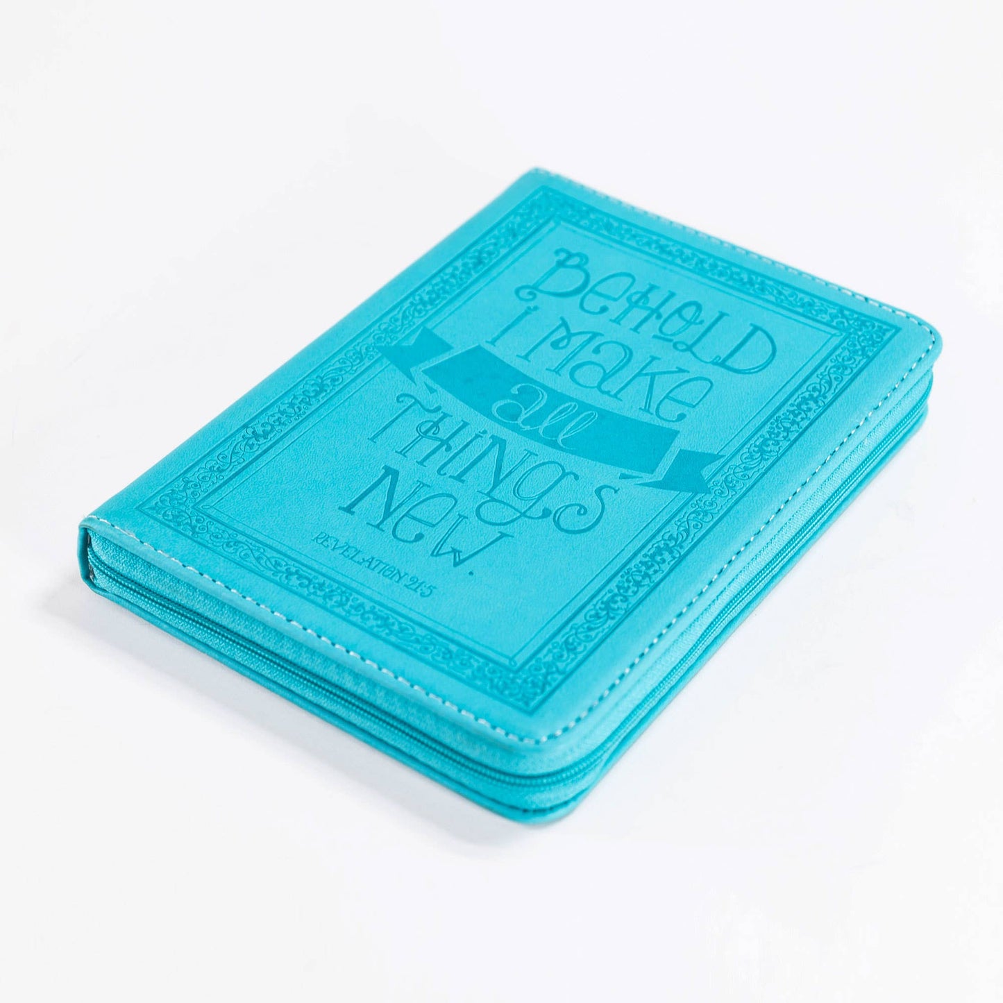 Turquoise notebook with embossed text on a white background