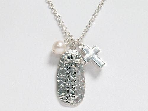 Silver necklace with a cross pendant and engraved pendant on a white background
