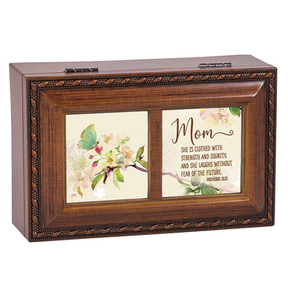 Wooden box with image of butterfly and phrase that says, Mom, she is clothed with strength and dignity, and she laughs without fear of the future. Proverbs