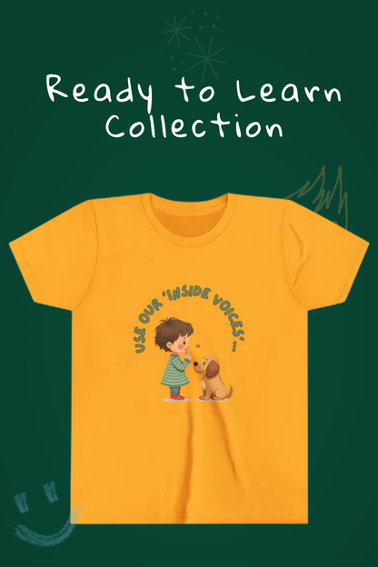 Ready to learn collection written on chalkboard. Mustard youth t-shirt graphic says use your inside voice.